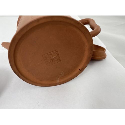 137 - A Chinese Yixing teapot with seal mark to base, integral strainer