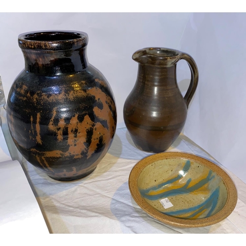 212 - A brown glazed studio pottery jug by David Leech, height 20 cm; an ovoid studio pottery vase with br... 