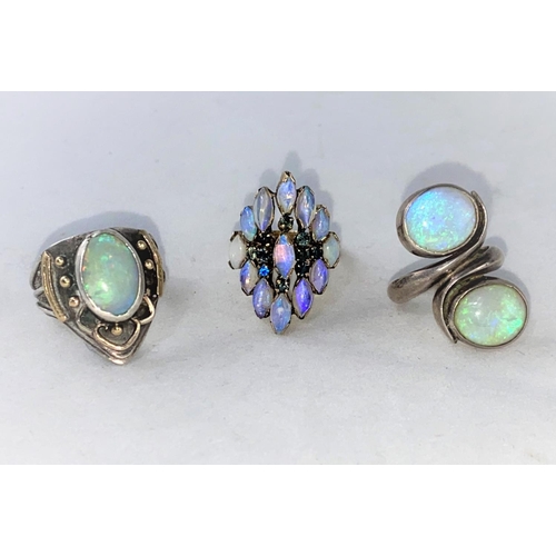 376 - A 1960's/70's modernist yellow metal dress ring with elliptical opal coloured stone and small blue s... 