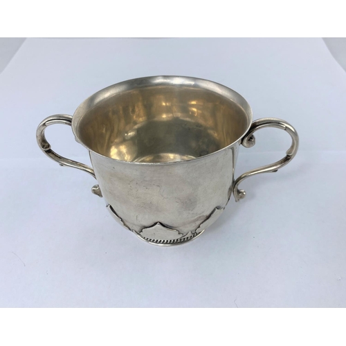 408 - A porringer with relief decoration to lower body and circular gadrooned foot, Birmingham 1921, 9.5oz... 