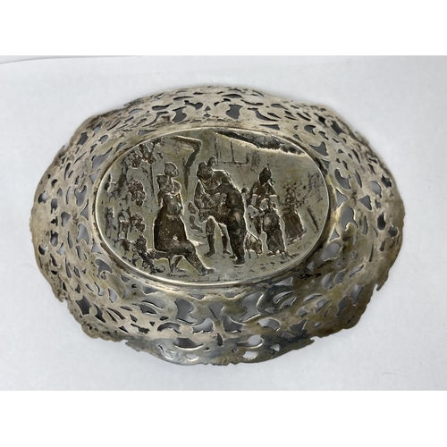 409 - An oval continental cast whit metal bon-bon dish with pierced acanthus and flowerhead decoration to ... 