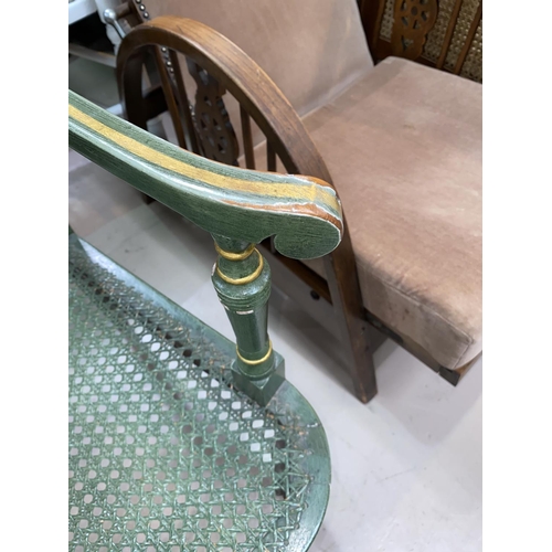 485 - A Regency style armchair with cane back, the seat in green and gilt finish