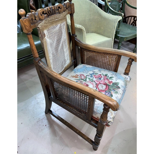 610 - An early 20th century Carolean style carved armchair with cane panels