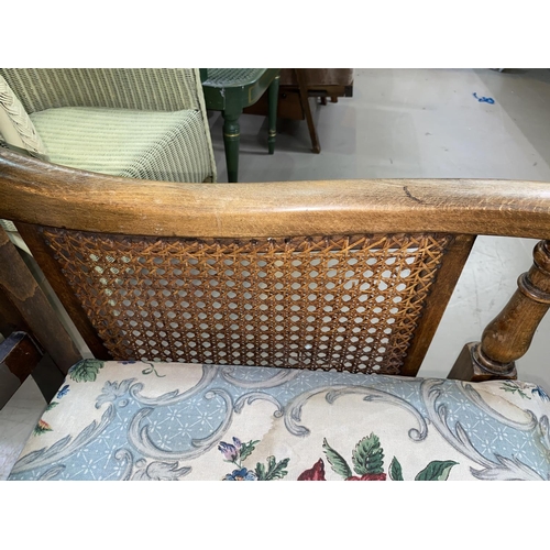 610 - An early 20th century Carolean style carved armchair with cane panels