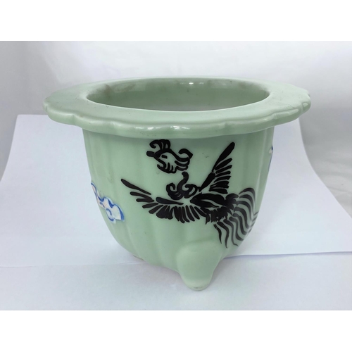 151 - A Chinese celadon jardinière with scalloped rim decorated with a phoenix and clouds, height 15cm, di... 