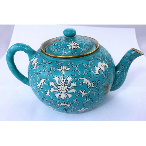 167 - A Chinese ceramic turquoise teapot with stylized floral decoration, gilt highlights, seal mark to ba... 