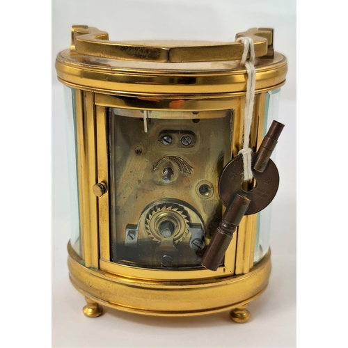 465 - A modern carriage clock in oval case with circular enamelled dial and timepiece movement, height 11 ... 