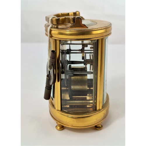 465 - A modern carriage clock in oval case with circular enamelled dial and timepiece movement, height 11 ... 