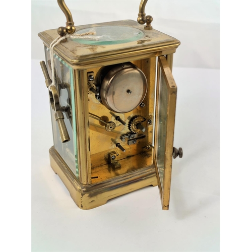 465 - A modern carriage clock in oval case with circular enamelled dial and timepiece movement, height 11 ... 