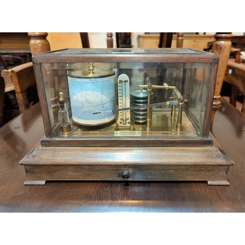 470 - A barograph in oak case by Armstrong, Manchester, length 37