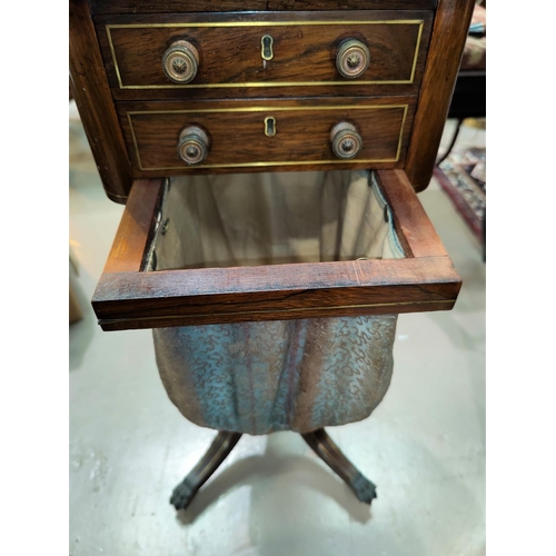 483 - A Regency period rosewood work table with brass inlay, of rounded rectangular form having 2 drawers ... 