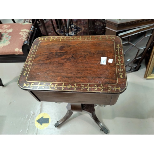 483 - A Regency period rosewood work table with brass inlay, of rounded rectangular form having 2 drawers ... 