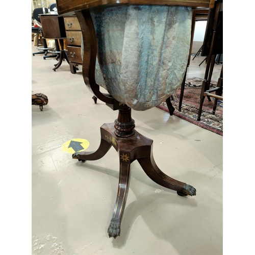 483 - A Regency period rosewood work table with brass inlay, of rounded rectangular form having 2 drawers ... 