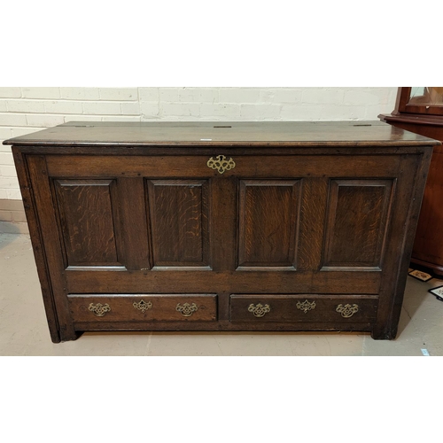 496 - An 18th century framed and panelled oak mule chest, with raised fielded front panels and 2 base draw... 