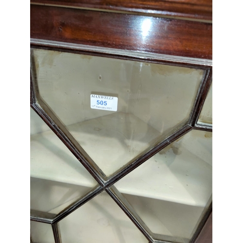 505 - A 19th century mahogany corner cupboard with straight front, enclosed by astragal glazed door