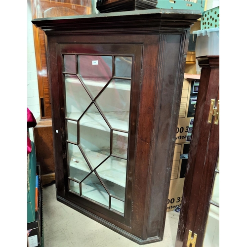 505 - A 19th century mahogany corner cupboard with straight front, enclosed by astragal glazed door