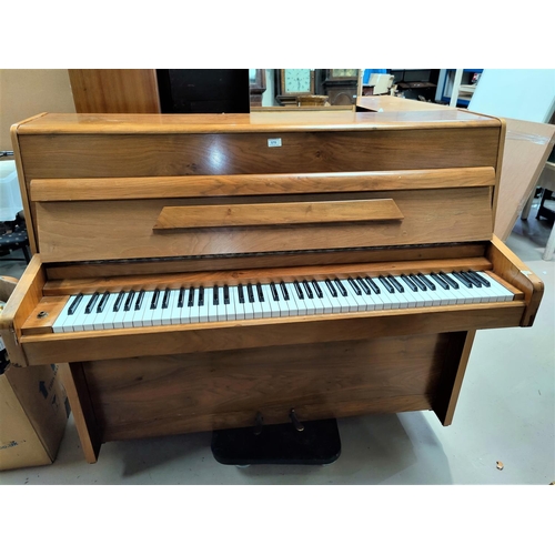 570 - A modern piano by Danemann, iron framed and overstrung, in walnut case with stool