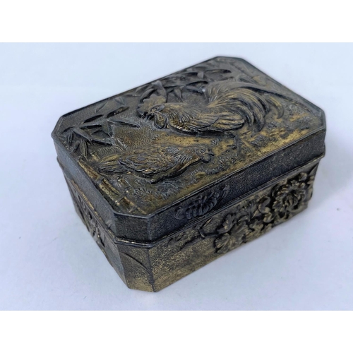 134 - A small oriental silvered metal box, decorated with cock and hen, other similar items including fine... 