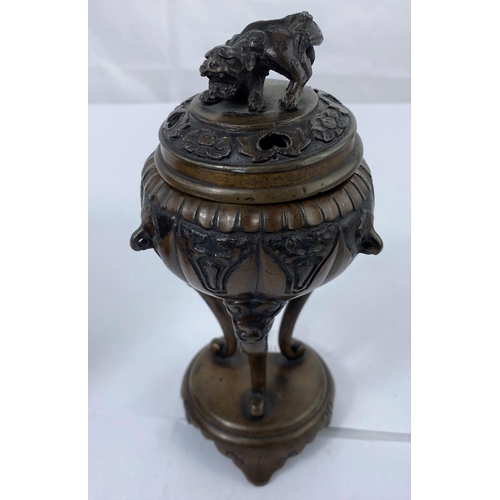 141A - An oriental bronze censor of rounded form with three feet attached to base with Dog of Fo on top, he... 