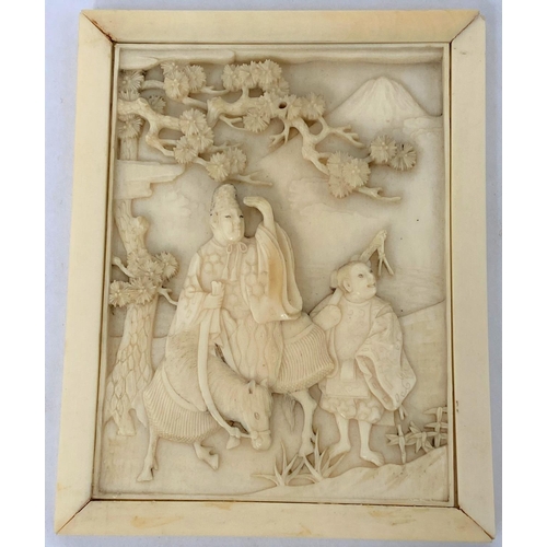 176 - A late 19th / early 20th century Japanese ivory carved panel of travelers featuring Mount Fuji in ba... 
