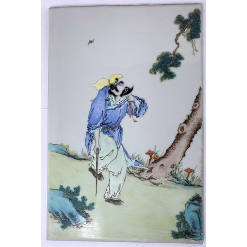 177 - A Chinese porcelain tile with polychrome decoration of man walking with stick, 38 x 25cm