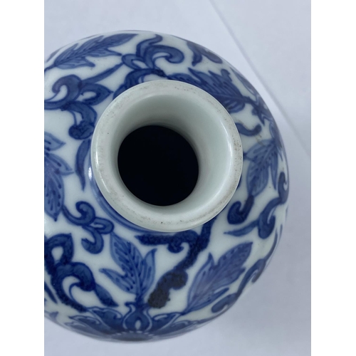 181 - A Chinese blue and white vase with floral decoration with double circle mark to base, height 19cm