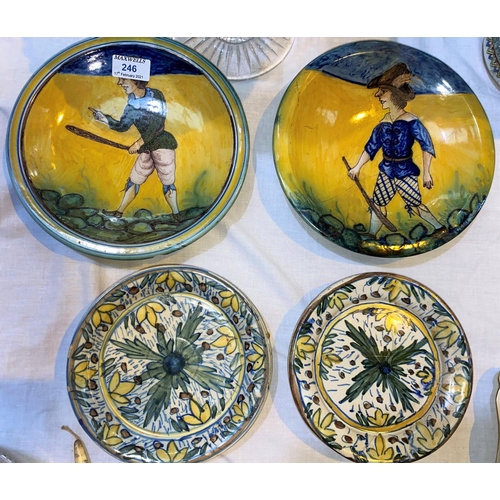 246 - A pair of majolica dishes decorated with men holding clubs, diameter 24 cm (1 broken and glued); a s... 