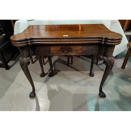 493 - An early/mid Georgian mahogany card table with triple folding top and outset rounded corners, frieze... 