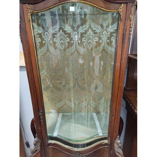 548 - A late 19th / early 20th century ormolu mounted Louis XV style serpentine front vitrine in the Verni... 