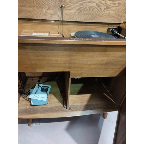 561 - A 1960's Ercol stereo cabinet with hinged lid and 2 doors