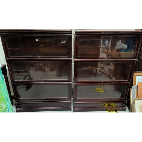 583 - A pair of stained mahogany 3 height sectional bookcases with drawers to base, by Globe Wernicke