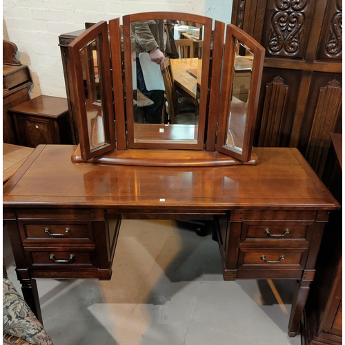 599 - A near matching bedroom suite comprising kneehole dressing table, mirror, chair and 3 height chest o... 