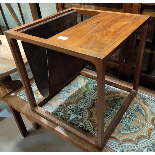 632 - A 1970's teak and suede magazine table, 44 cm