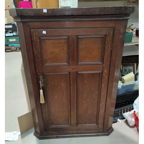 654 - An oak single panel door corner cupboard 104 x 75cm