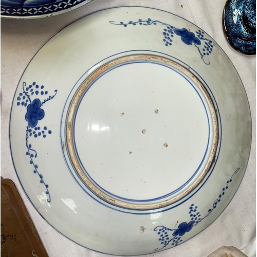 145 - A pair of large Japanese blue and white chargers with traditional country scenes, diameter 146cm