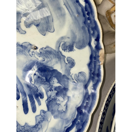 146 - A large Japanese blue and white charger decorated with dragon, scalloped edge, diameter 47cm, 3cm ch... 