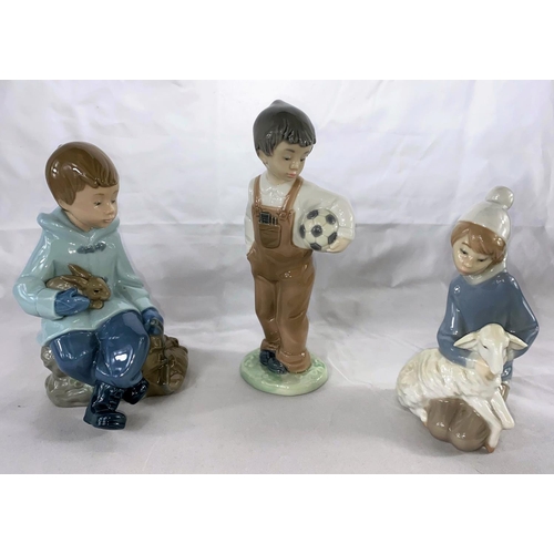 248B - A Lladro young girl kneeling holding a lamb; 2 Nao boys, 1 with football, 1 with a rabbit