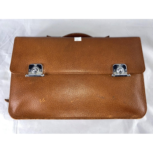 410 - A gent's brown leather overnight bag fitted with engine turned silver back brushes and silver top bo... 