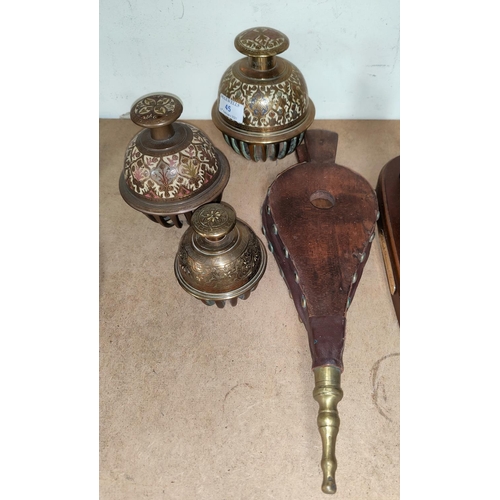 45 - Three graduating Middle Eastern elephant claw bells and a set of wood and leather bellows
