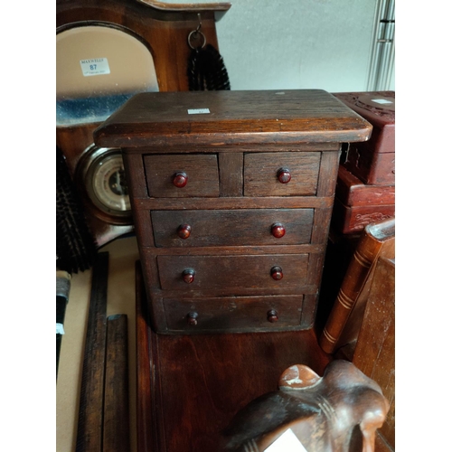 87 - A 1930's stained wood barometer/brush rack; a walking stick; a miniature chest of drawers; etc.