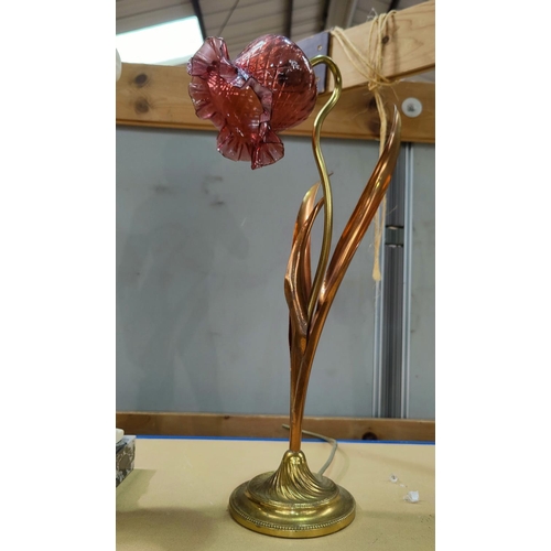 108 - An Art Nouveau brass and copper table lamp with pink glass shade