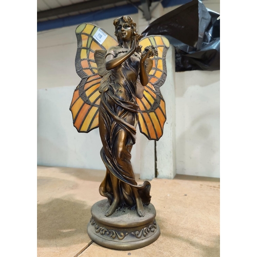 118 - An Art Nouveau style table lamp in the form of a bronze fairy with coloured and leaded butterfly win... 