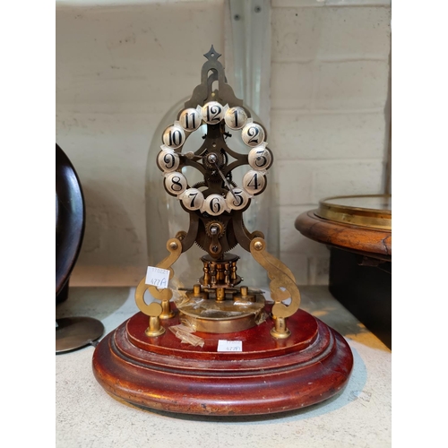 477A - A 400 day brass skeleton clock with silvered individual  numerals, under glass dome on mahogany plin... 