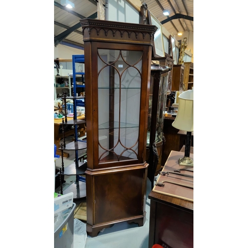 521A - A reproduction full length corner display cabinet in mahogany, with glazed and panelled doors, on br... 