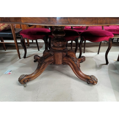 545 - A 19th century shaped oval burr walnut loo / dining table on carved and turned baluster column and q... 