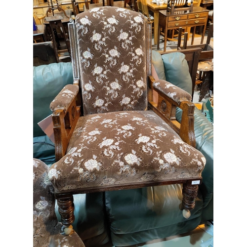 617 - A Victorian armchair in embossed floral fabric with high back