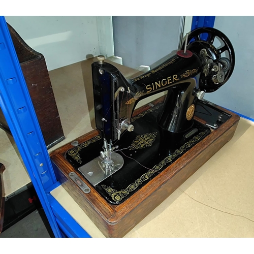 84 - A Singer hand operated sewing machine in oak case