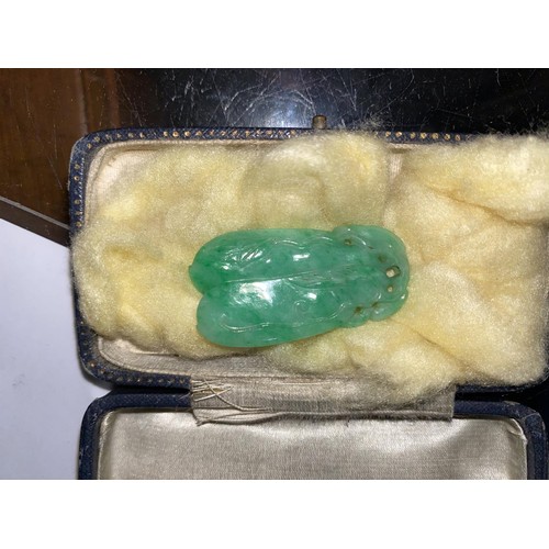 135B - A Chinese light green jade coloured pendant in the form of two pieces of fruit