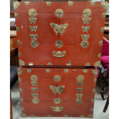 171 - A pair of late 19th / early 20th century Chinese red lacquer cabinets with brass binding, with doubl... 