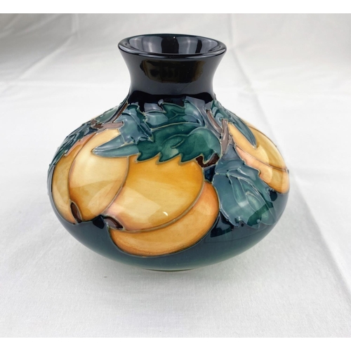 12 - A squat circular Moorcroft vase decorated with apricot type fruit & green leaves impressed diameter ... 